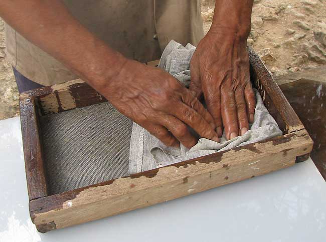 The fibers are blotted through the frame's wire screen.