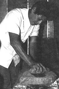 Dionisio preparing charcoal from the fireplace, for medicinal purposes