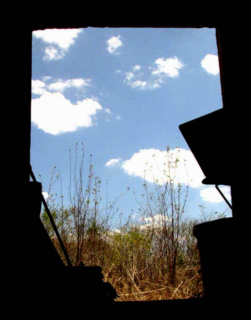 clouds seen through door